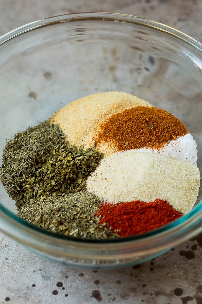 A bowl full of different dried herbs and spices.