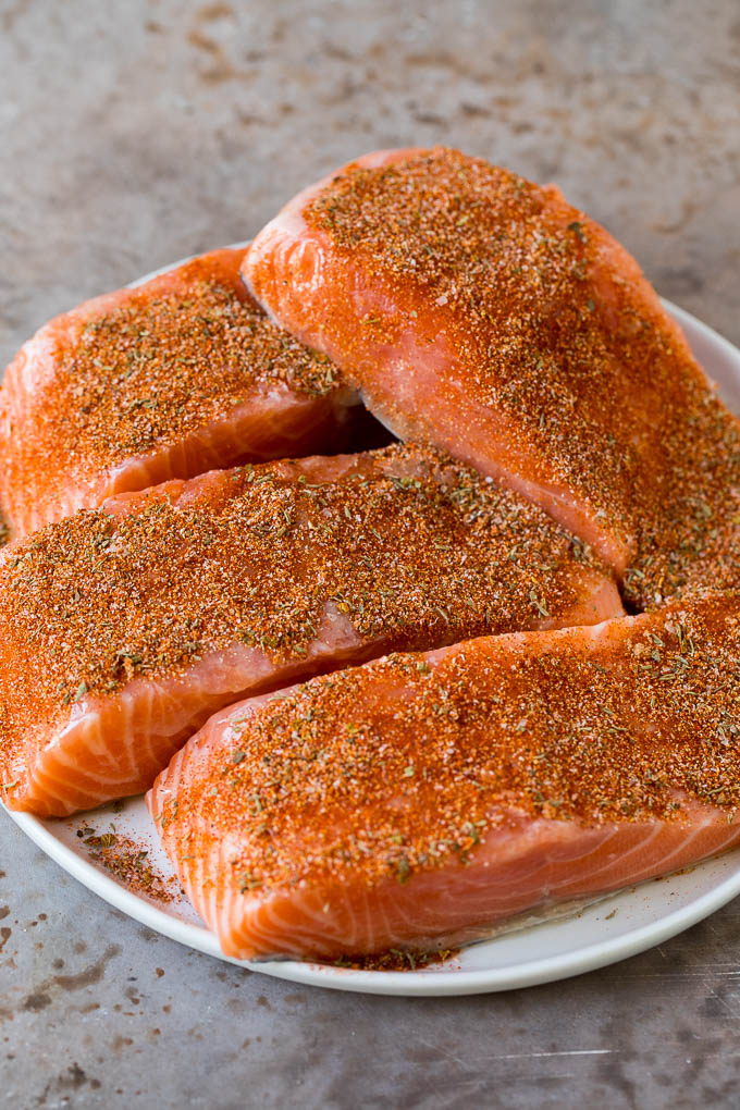 Salmon fillets coated with seasonings.