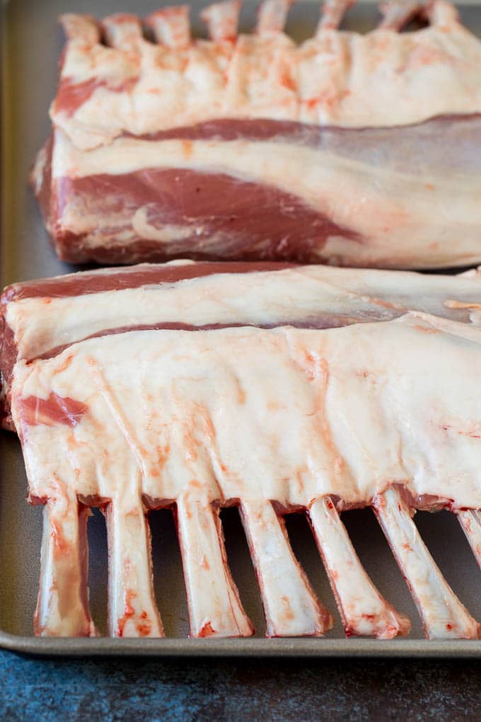 Raw lamb on a sheet pan.