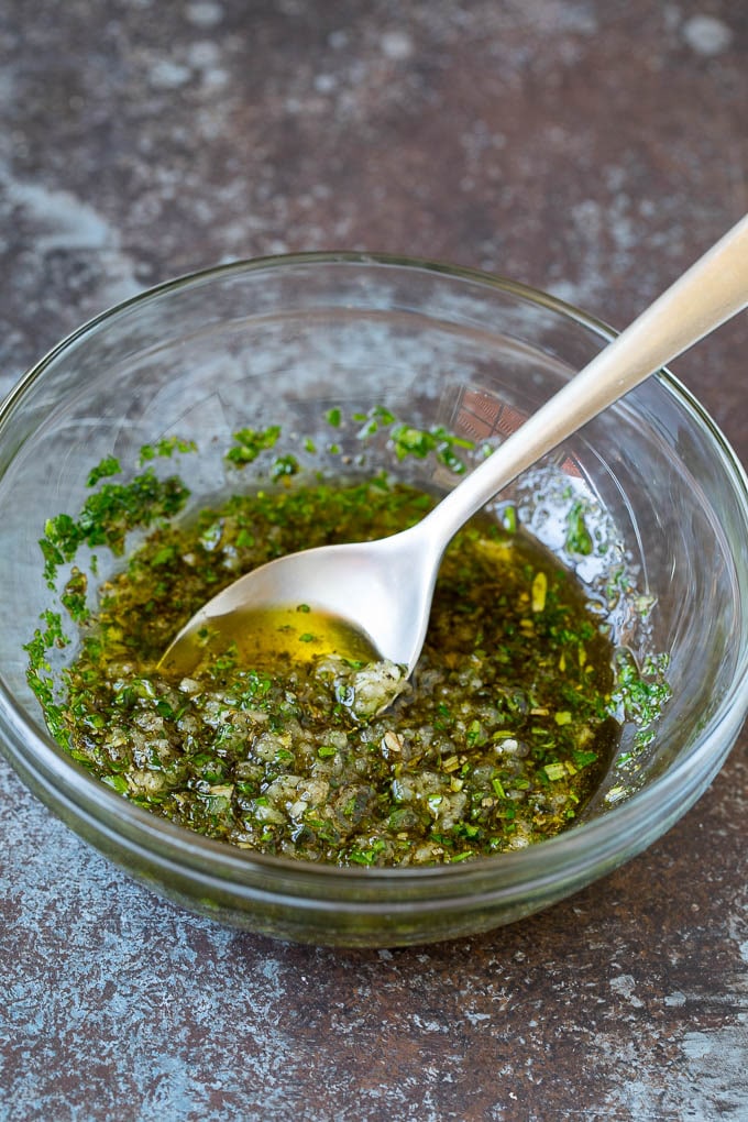 A bowl of garlic and herb olive oil.