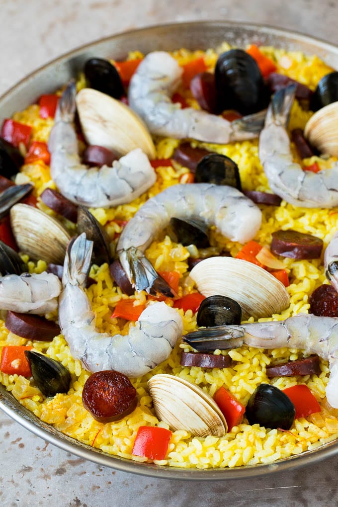 Raw seafood on a bed of saffron rice.